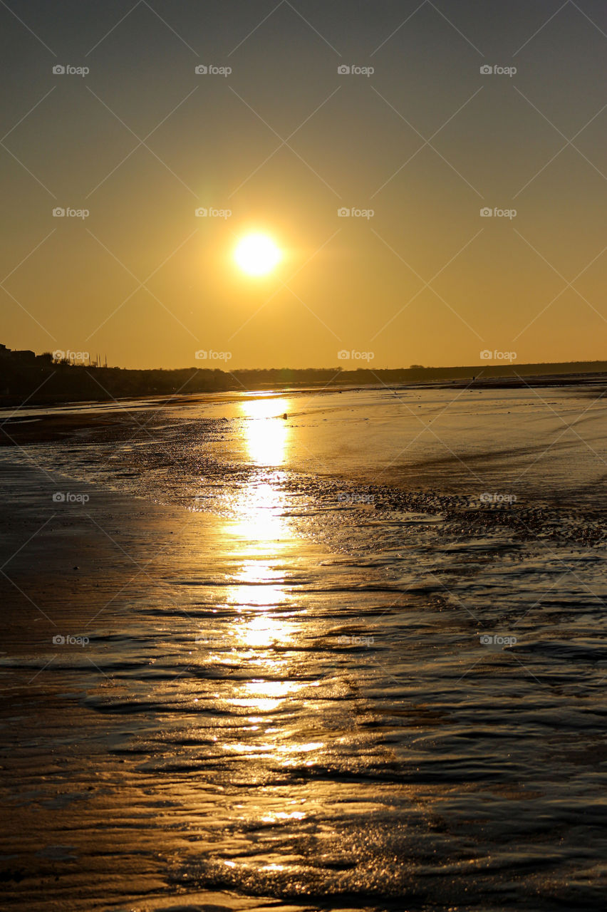 Reflection of the sun on a thin layer of Ice.