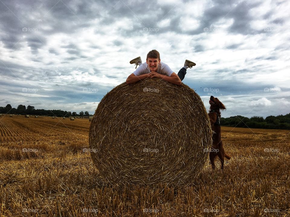 Fun in the countryside .. my son pulling faces on top of a hay bale with Quinn wanting to climb up and join him too 