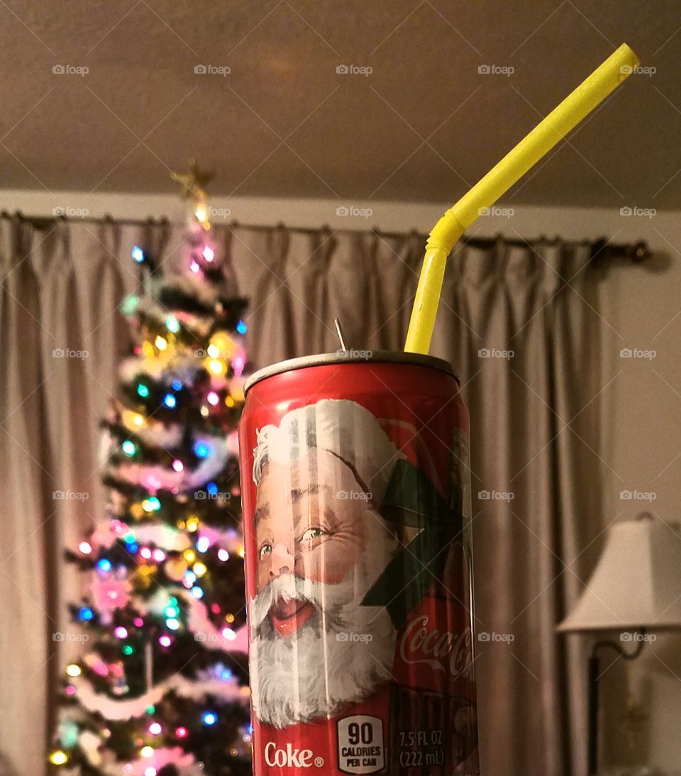Christmas Coca-Cola can with Christmas tree in the background