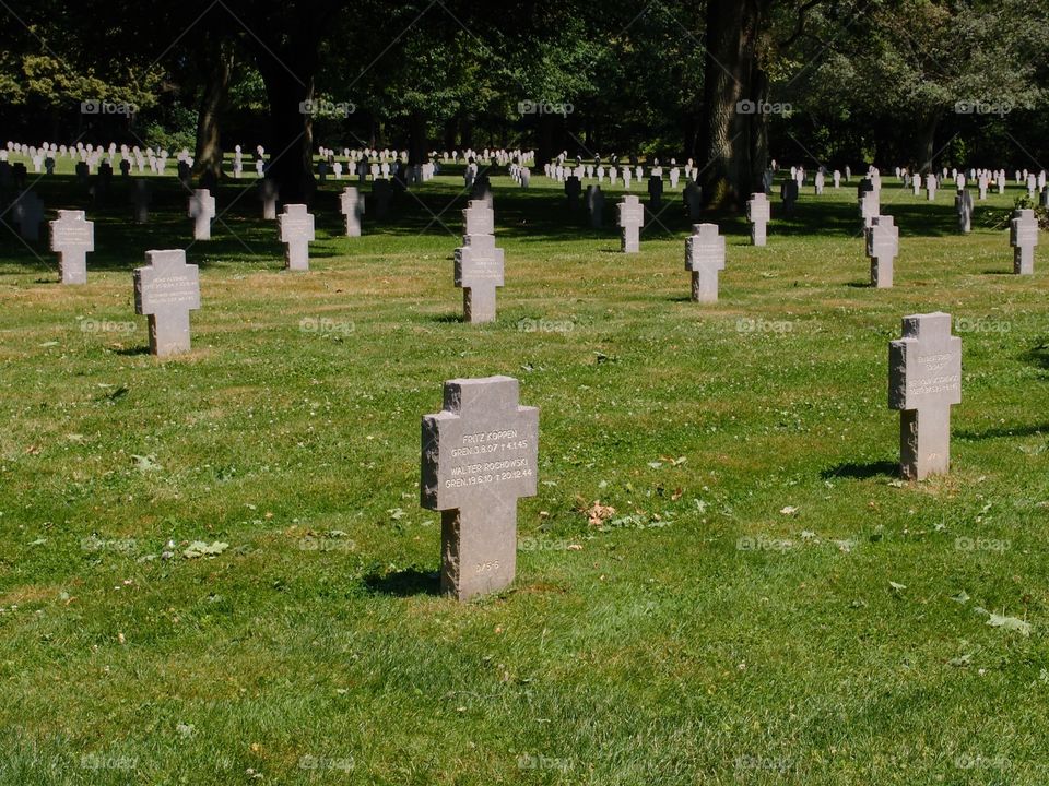 Beautiful finely carved tombstones of fallen German Soldiers in a beautifully landscaped cemetery outside of Luxembourg City on a nice summer day. 