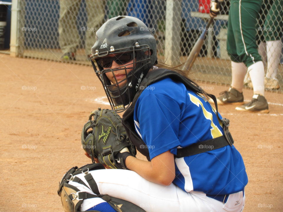 bring it. my daughter behind the plate looking to the dugout for the pitch call