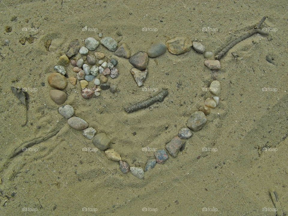 Elevated view of heart shape made by stones at beach