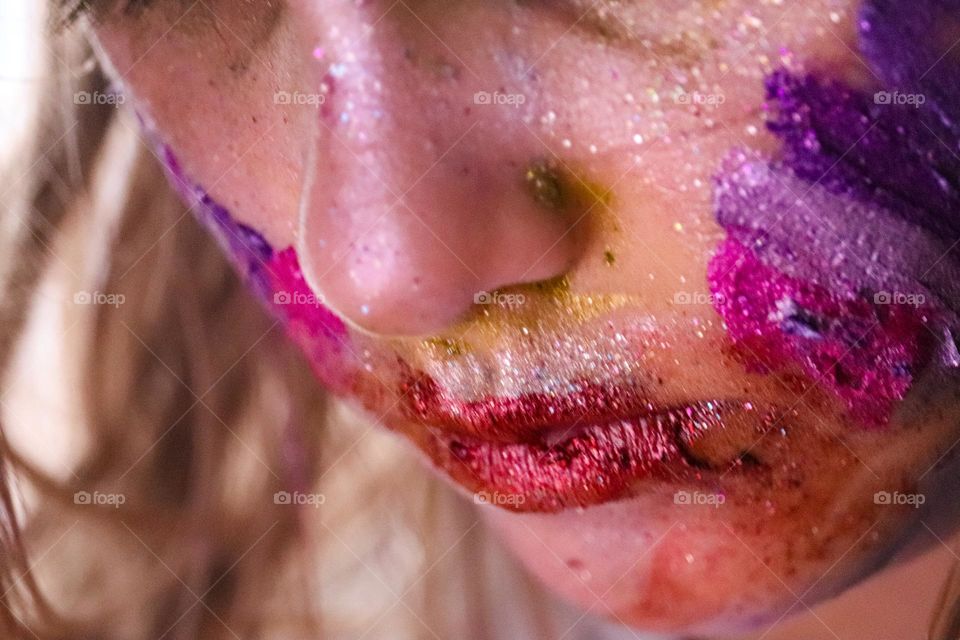 A child wearing glitter makeup