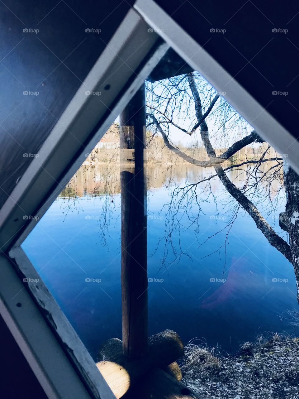 A view through the window to a lake 