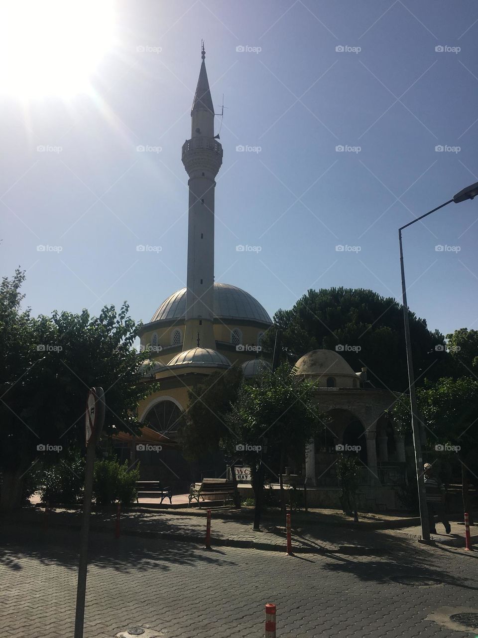 Sunset in Turkey. Blue sky and tall palm trees. Sunsets and sunny days. Summertime in Kusadasi. Vacation travel in Turkey . Summer view. Sunny day during vacation. Hidden gems and secret places.