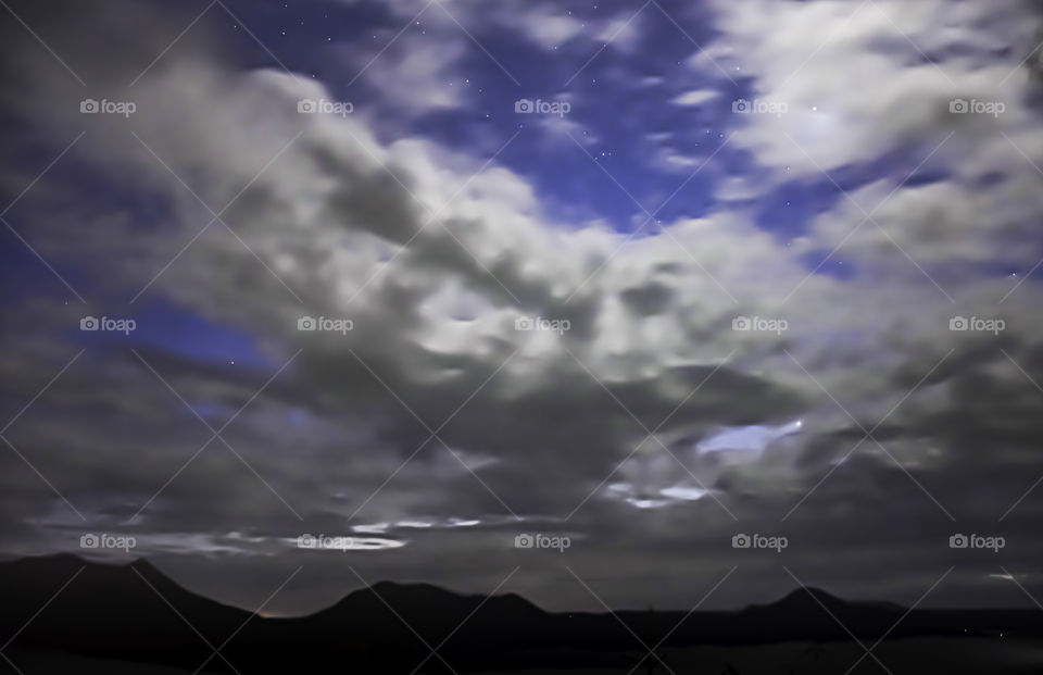 Sky with stars and the clouds are flowing Background fog and the mountain.