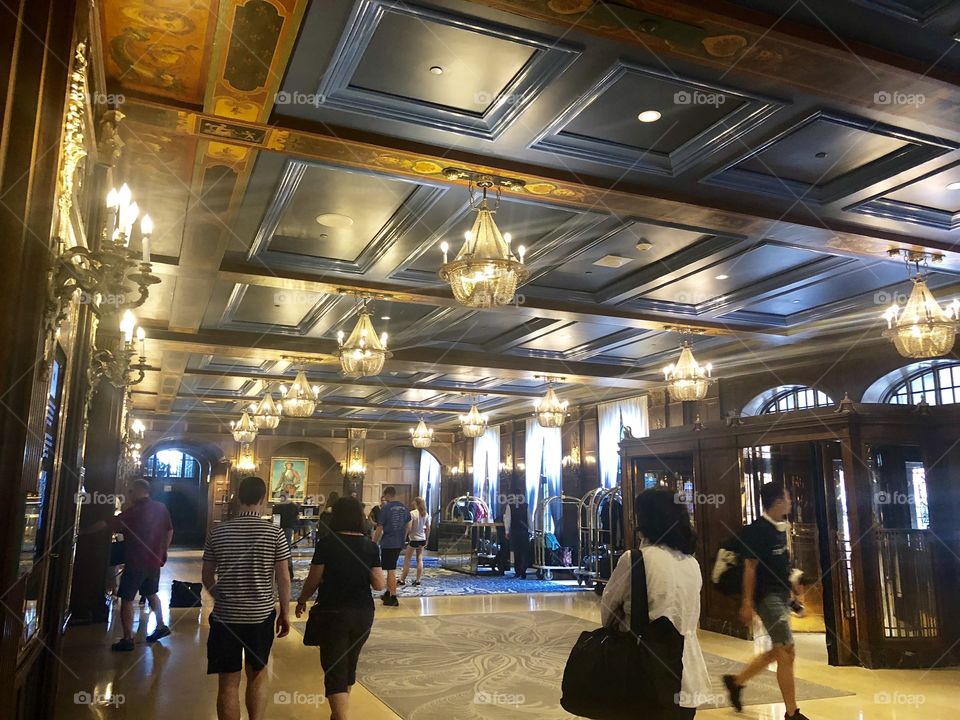 Luxurious hotel lobby that feature vintage architecture, wood ceilings and chandeliers 