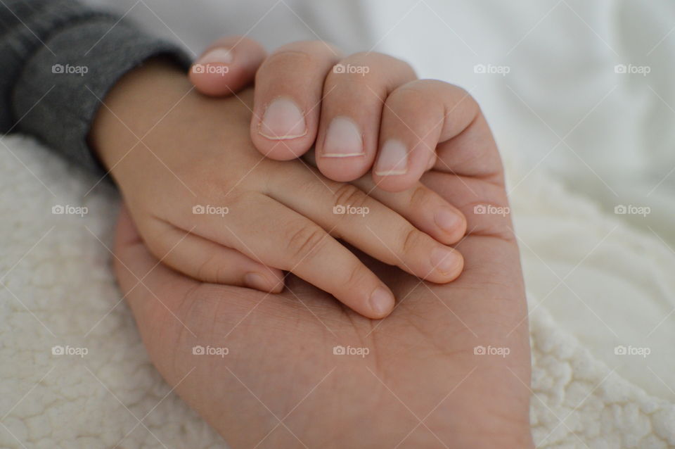 Man holding child's hand
