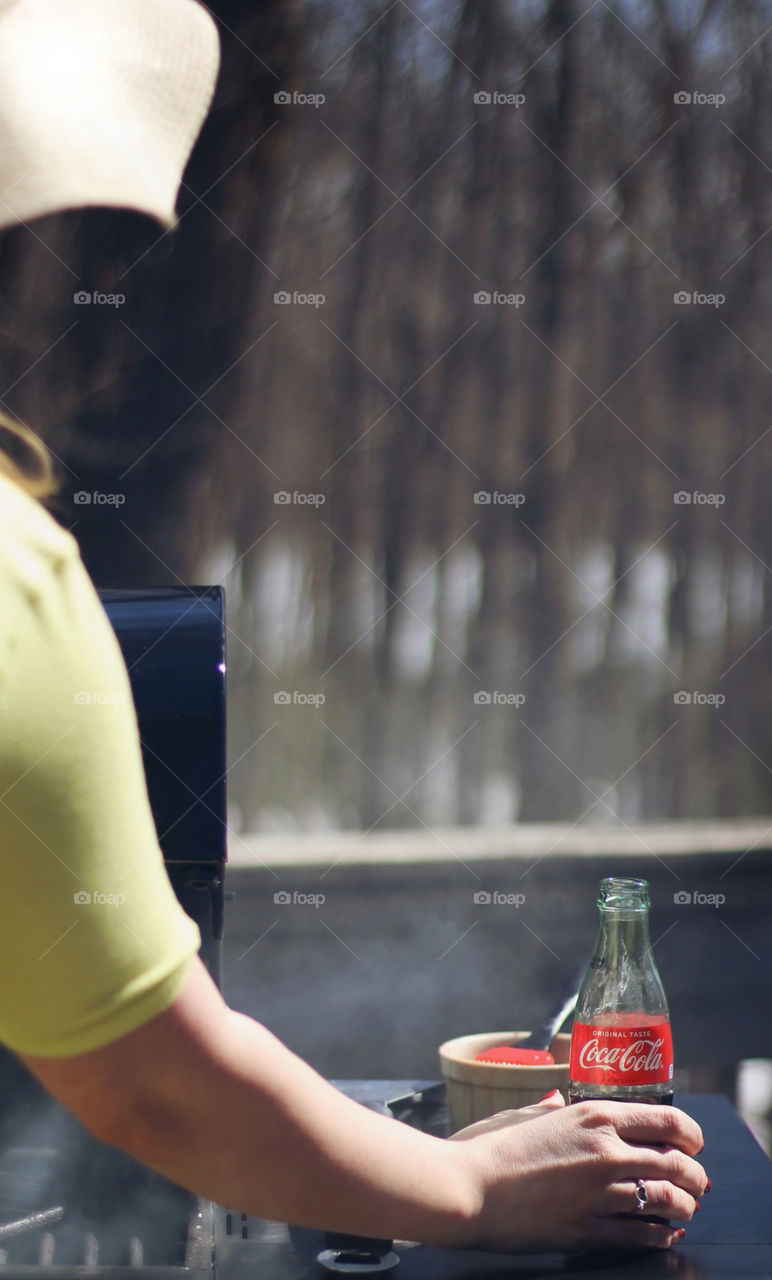 Woman grilling with coca cola