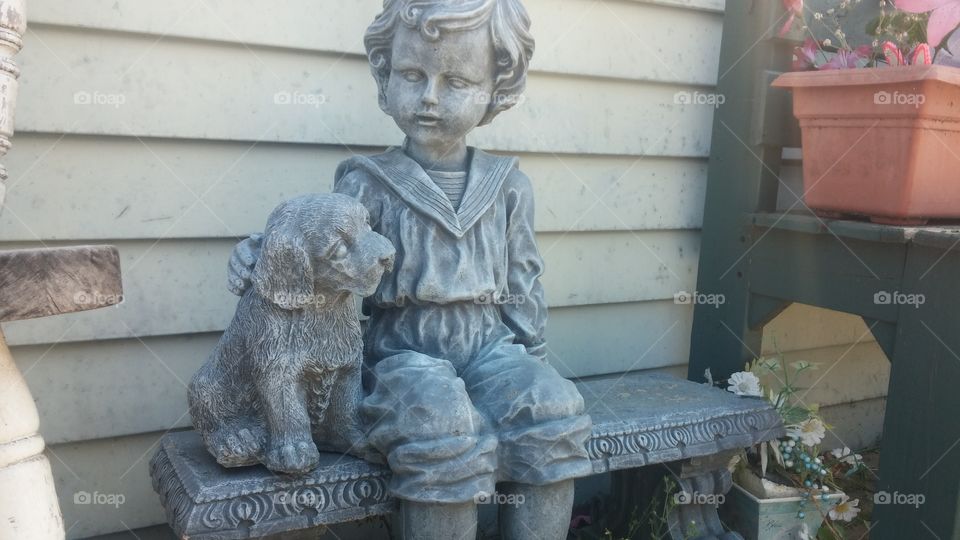 puppy and child statue. A porch decoration in a nearby neighborhood...