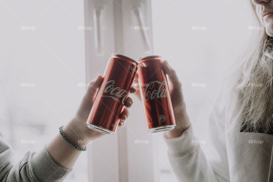 coca cola in hands / cheers with coca cola