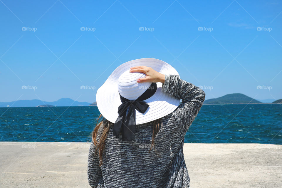 Woman standing at the sea shore