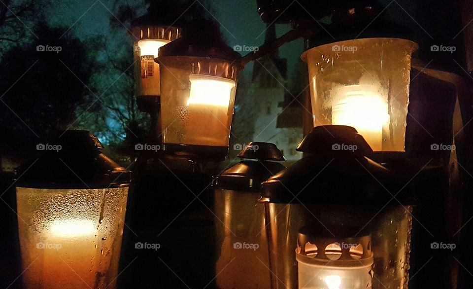 Light candles at the cemetery, which lights up in the dark.