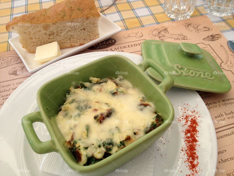 Meal in a green ceramic bowl on a table