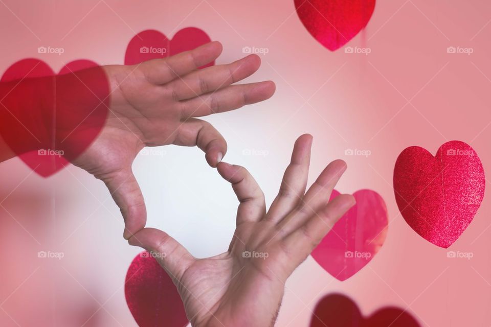 male hands making heart shape