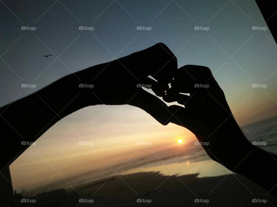 Sunset and hands intertwined.