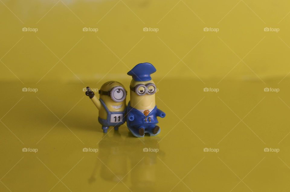 minion toys from kinder surprise on yellow background.