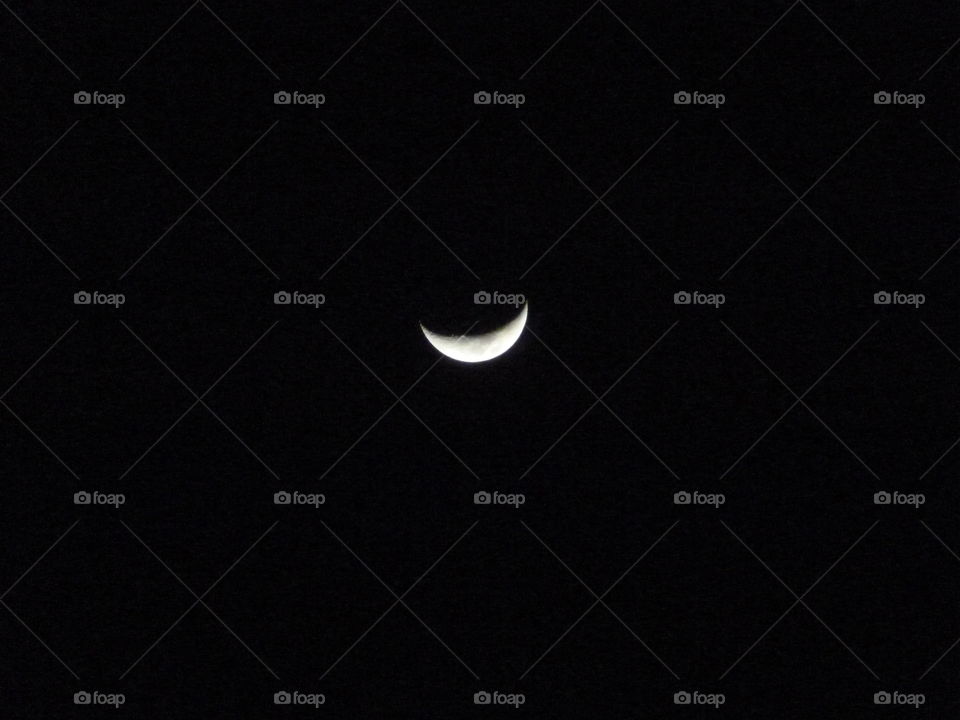 Crescent moon in dark sky