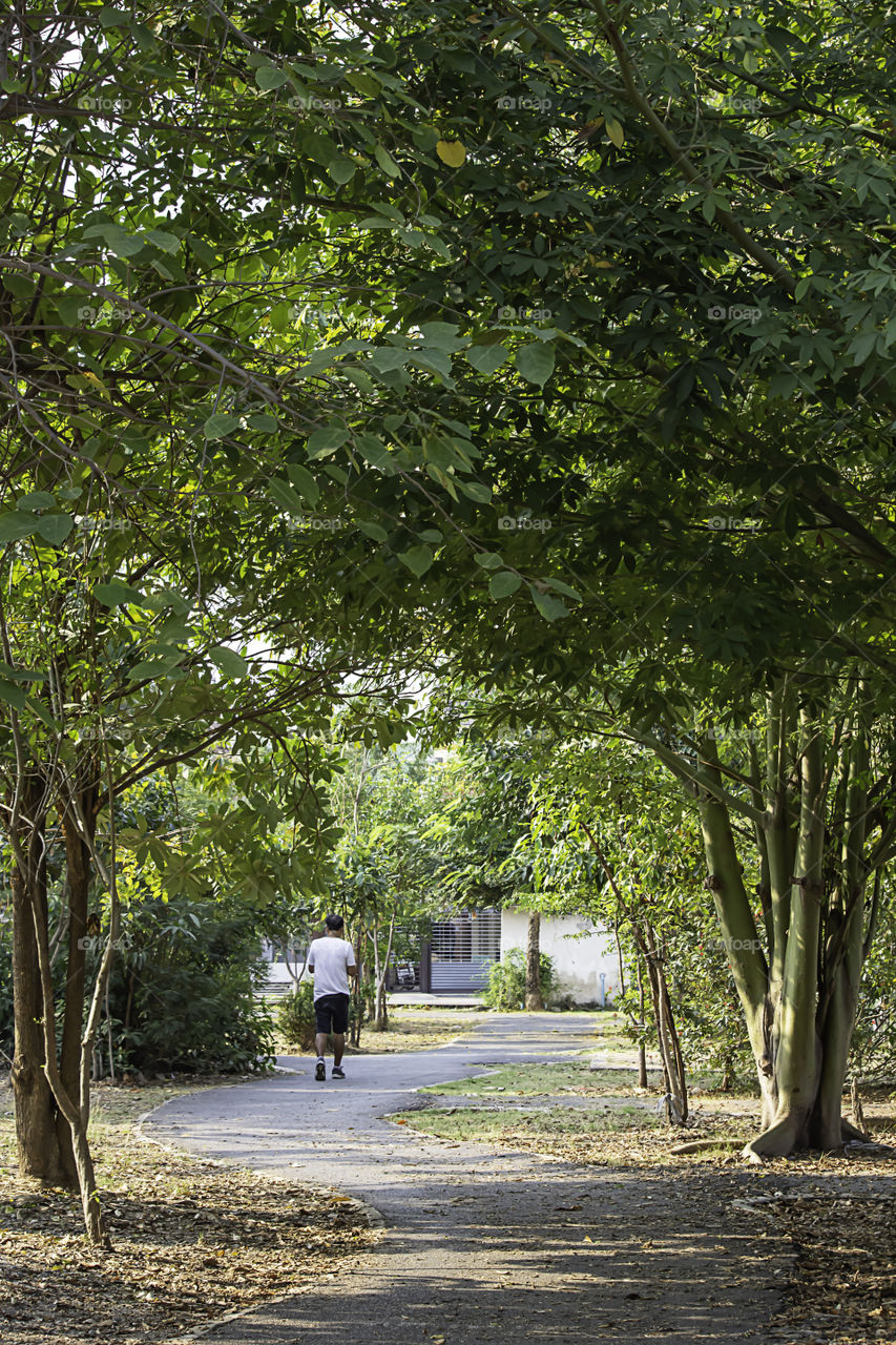 Man running exercise for health in the BangYai park , Nonthaburi in Thailand.