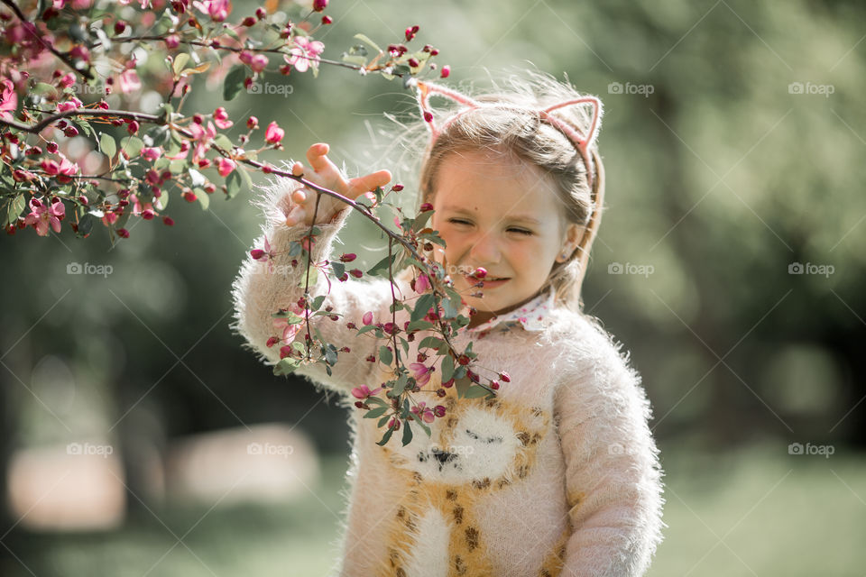 Cute Little girl in a blossom park