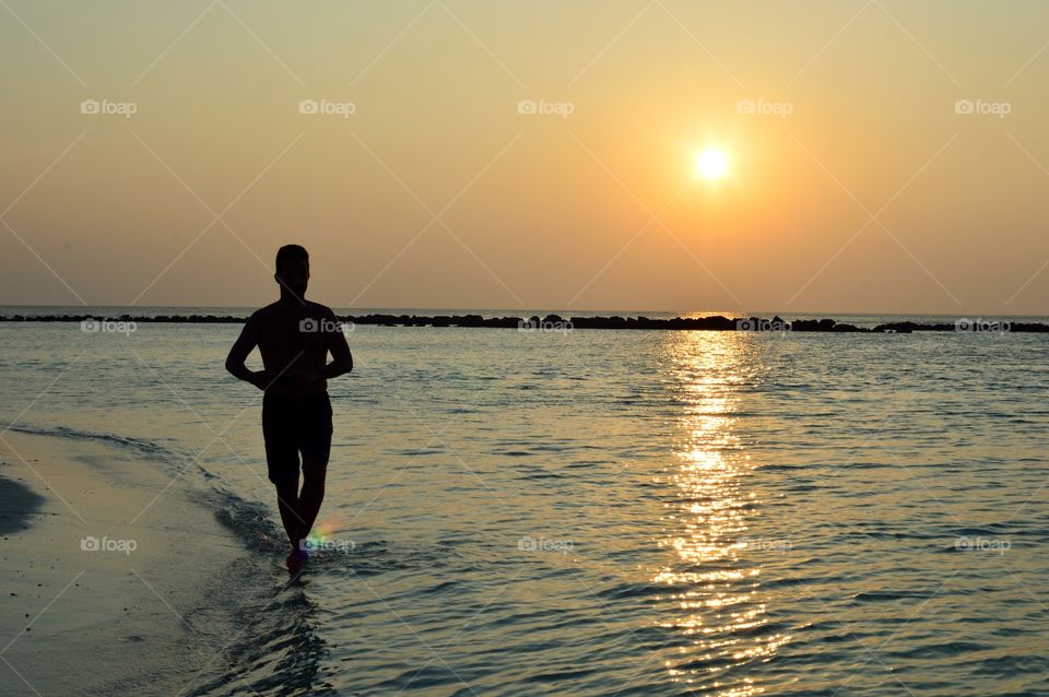 Running at sunset on the beach