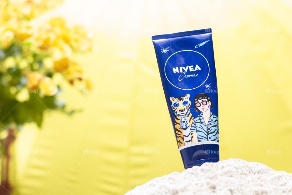 NIVEA crème in front of yellow umbrella. 
Spirit of brave, adventurous, and passion!
