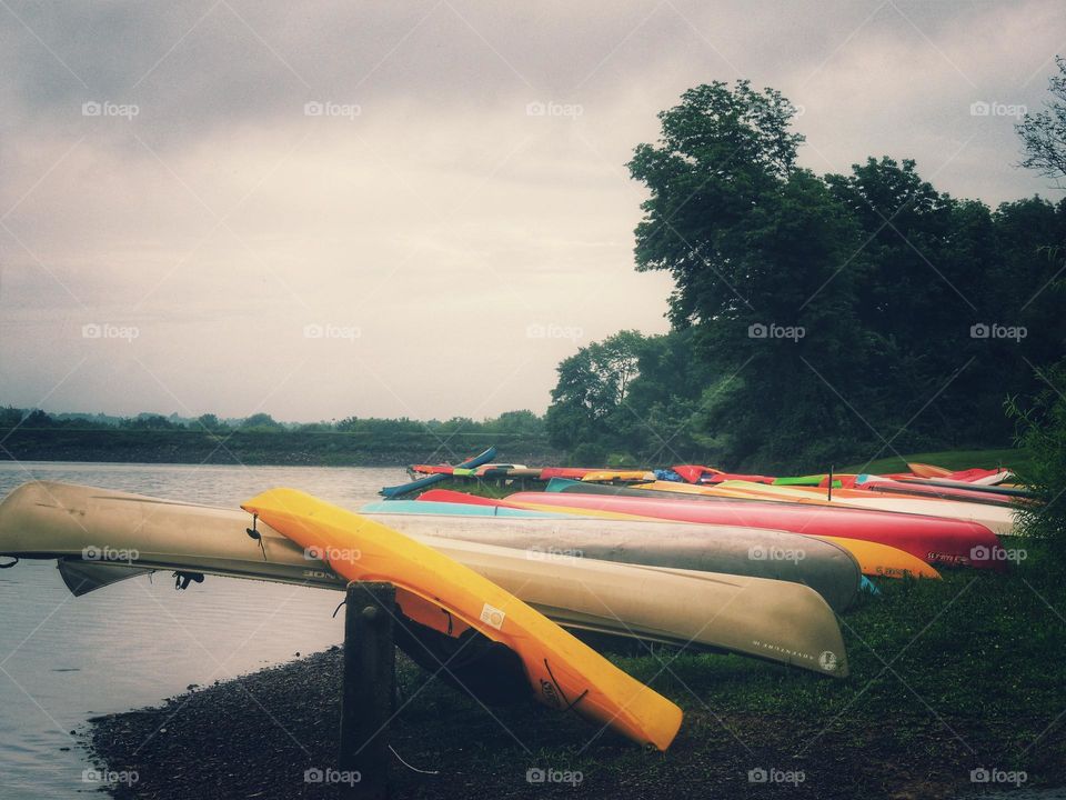 colorful canoes lakeside