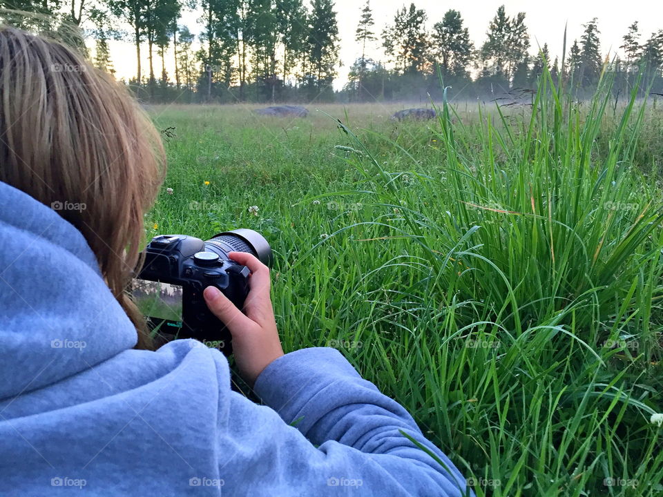 Girl snapping photos in the evening fog