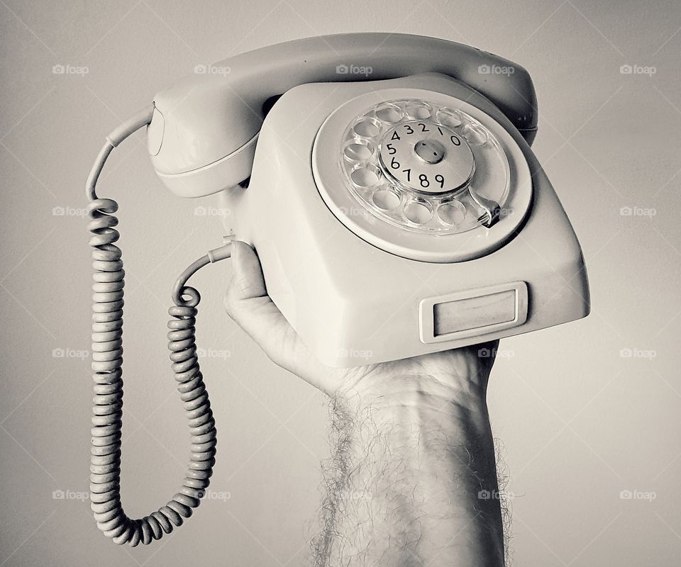 Hand holding old school telephone 1