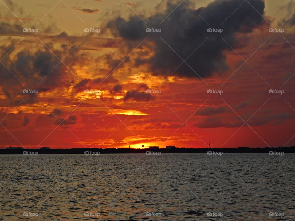 
Mesmerizing sunset - Bright streaks of red, yellow and orange slowly overcame the dark black sky. The sky resembled a prism; all the colors blended perfectly into each other.