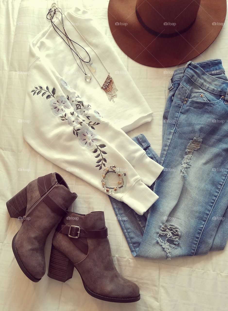 flat lay clothes jeans shirt hat boots