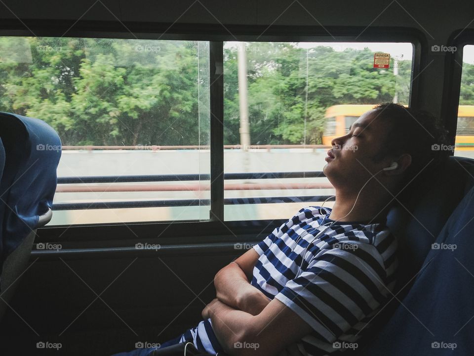 Indians commute from one place to other by bus and  music and sleep are one of the most favourite activities in their journey