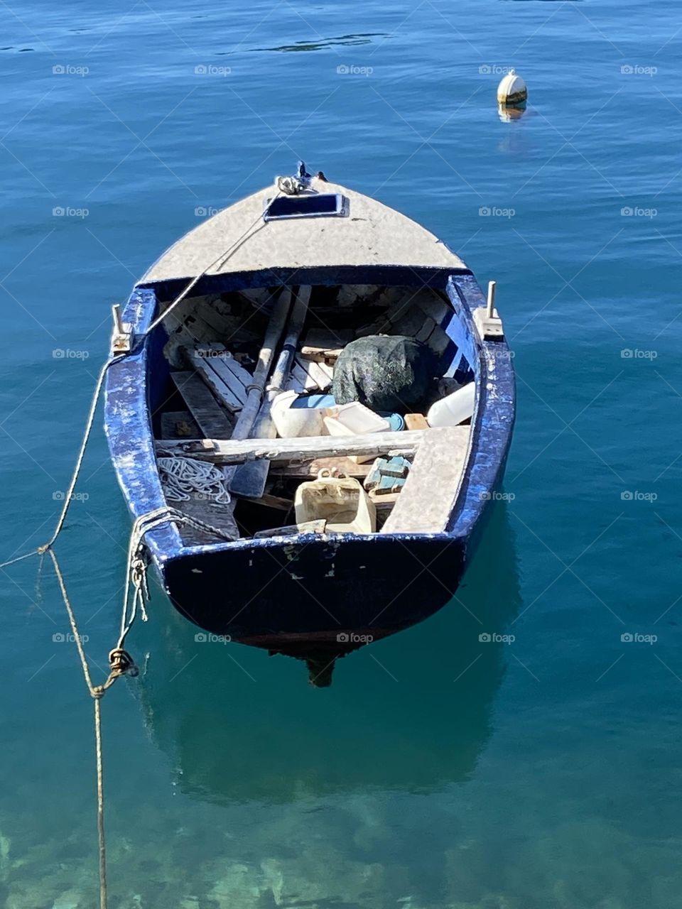 Blue boat on blue sea.