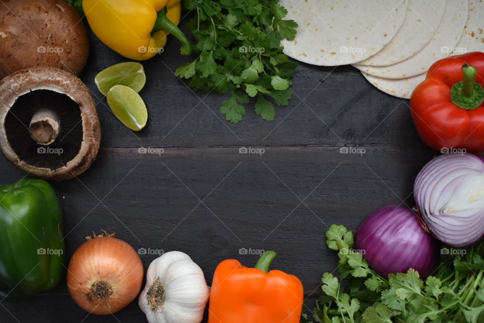 Vegetables and tortillas on a wood background 