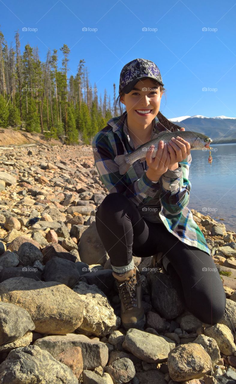 Girl fishing for trout in Colorado. 