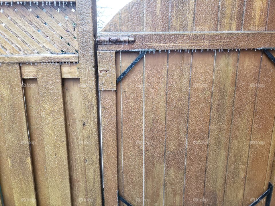 icicles on wooden gate