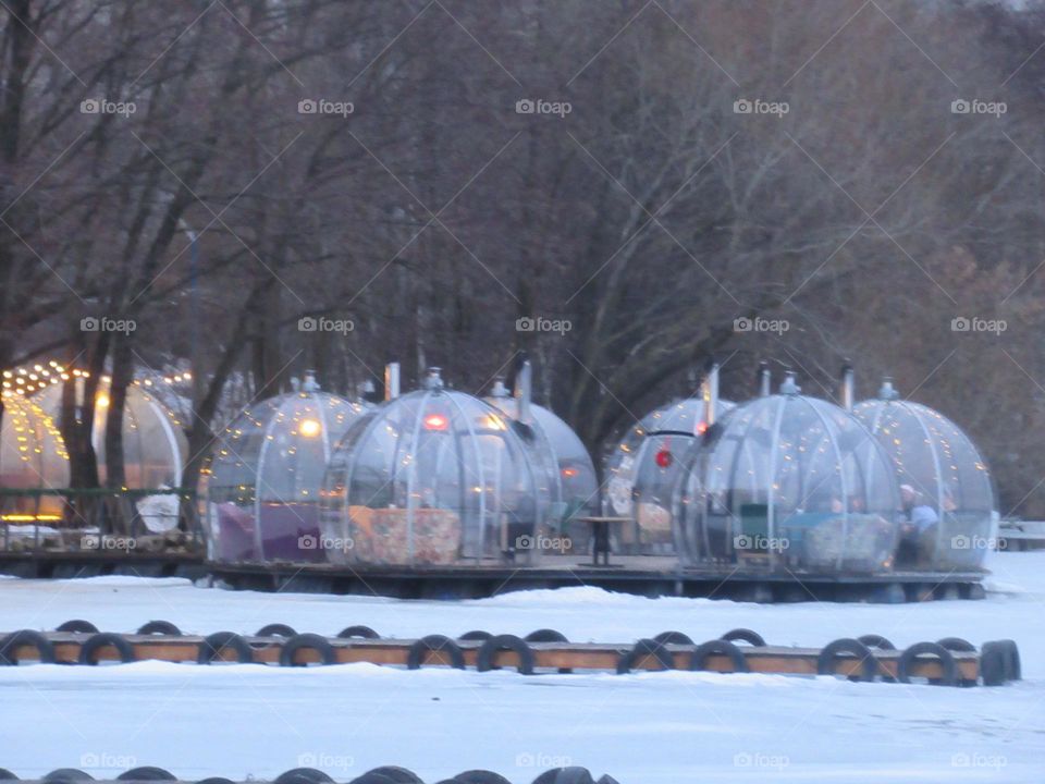 cafe on the river bank, in winter, the water is frozen, it’s warm inside, you can relax and enjoy the view of the river
