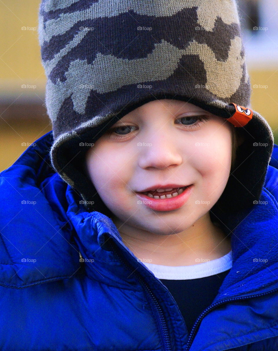 Close-up of a boy wearing hat