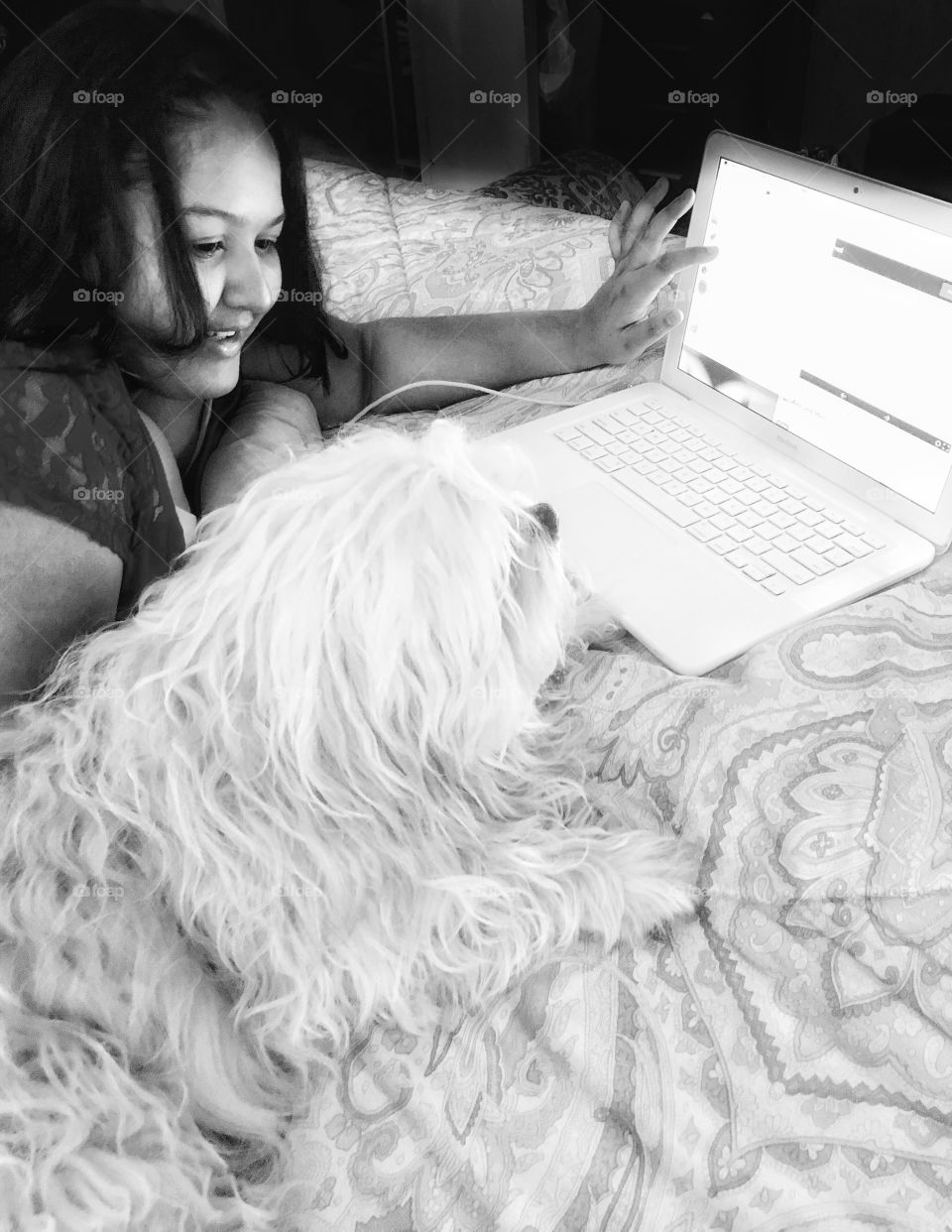 Dog and girl lying on bed