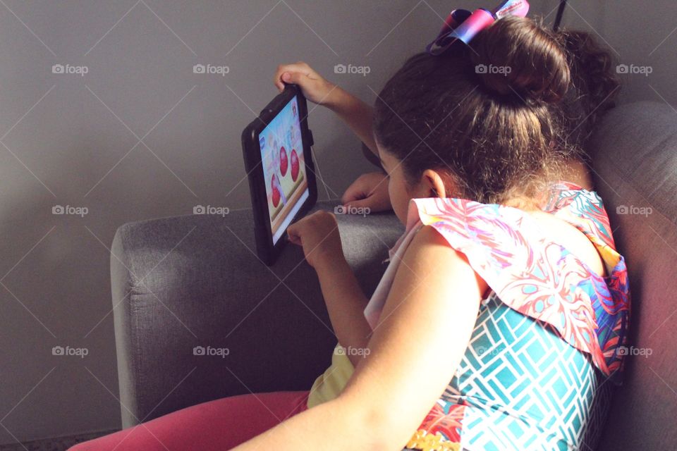 Little girls playing on the iPad