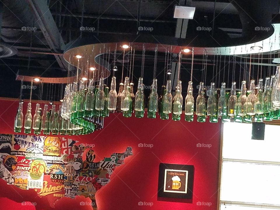 Unique lighting in a Texas restairant made with recycled glass bottles