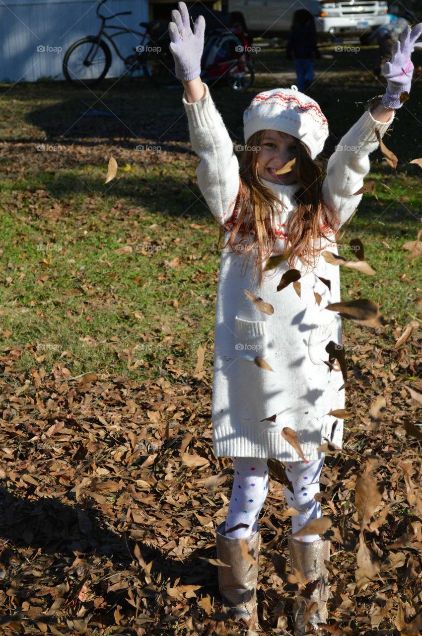 Dry leaves falling on cute girl