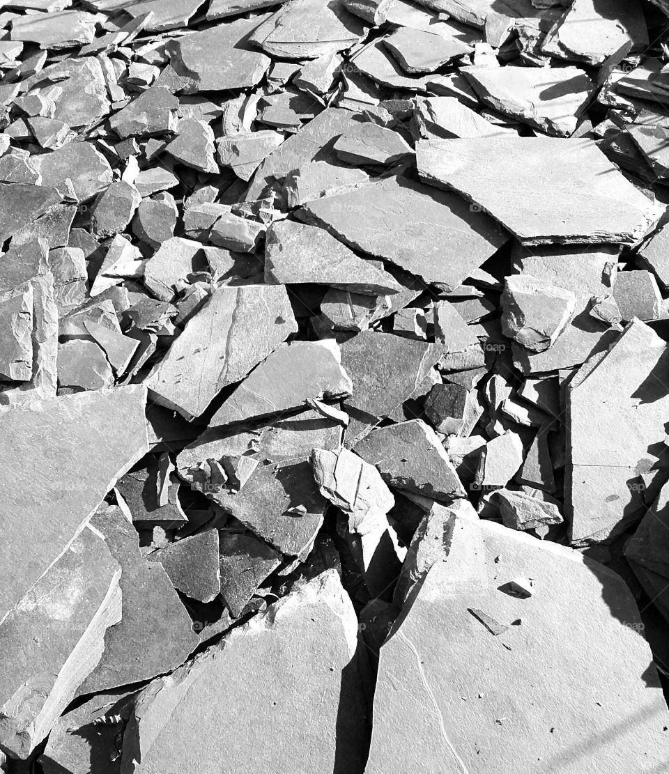 Grey slate chippings with shadows cast by strong winter sunlight