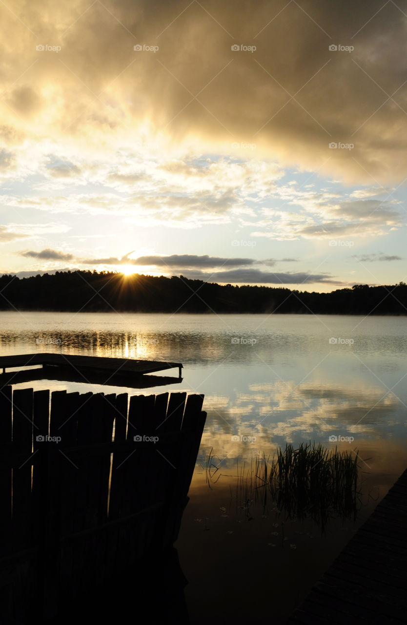 lakeside silhouettes during sunrise at the lake in Poland