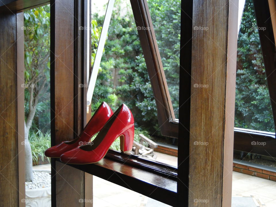 Red shoes on window