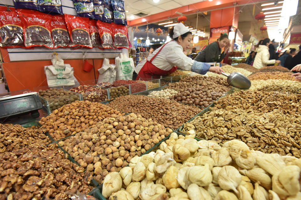Asia, china streer food, at the Market. Harbin indoor marked. nuts seller. many nuts . walnuts