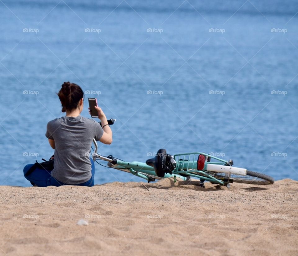 Girl taking selfies on the beach 