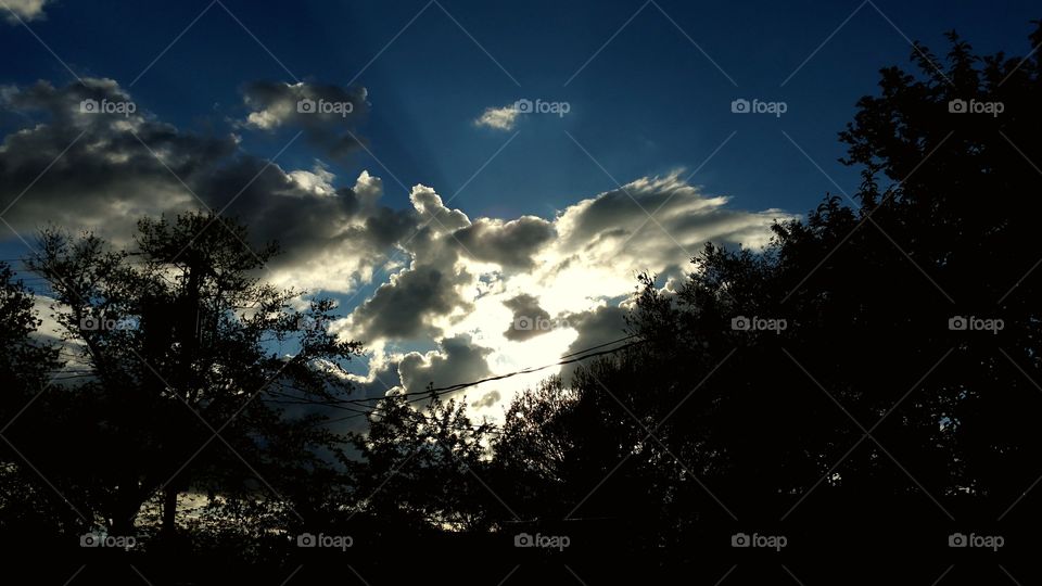 sun behind clouds