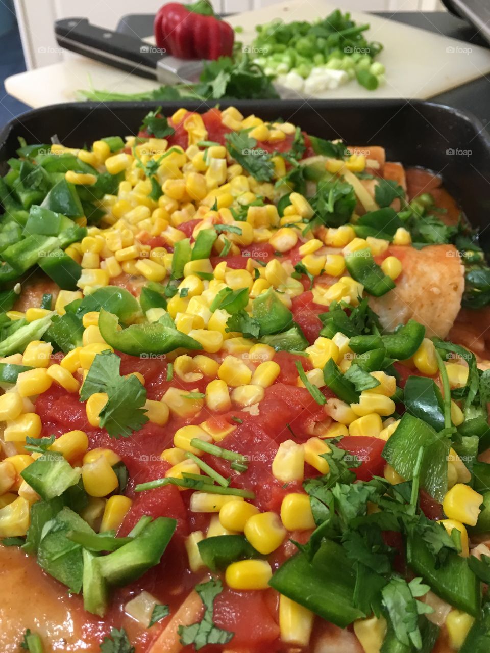 Mexican food at its best, minced beef enchiladas topped with a healthy mixture of corn, cilantro (coriander) tomatoes, sauce and cheese of course