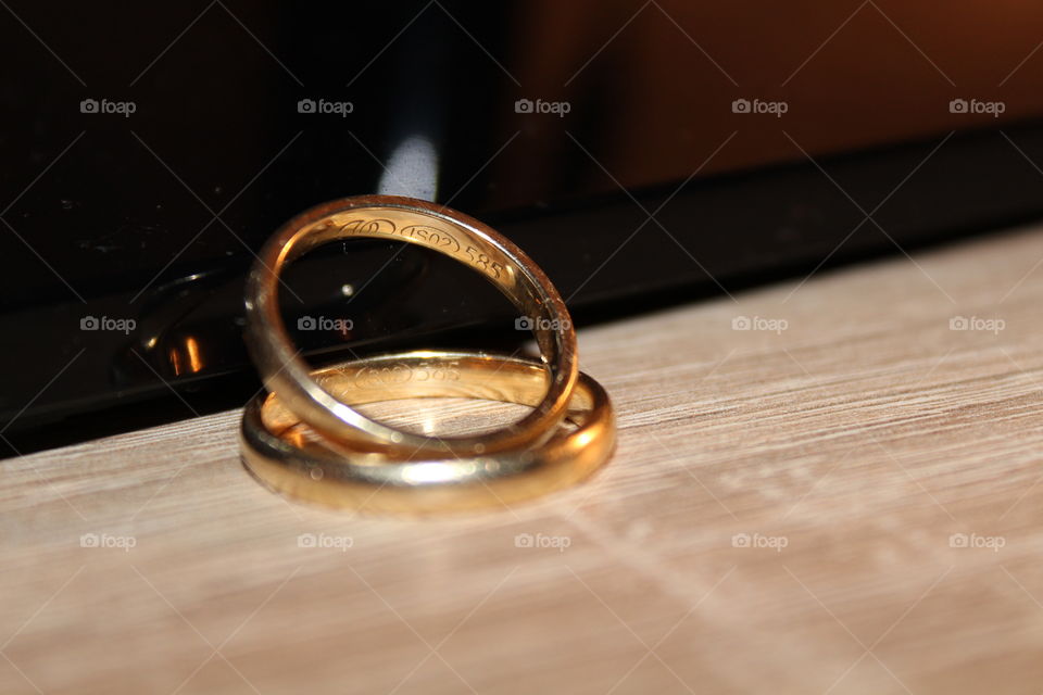 wedding rings on a wooden table close-up micro